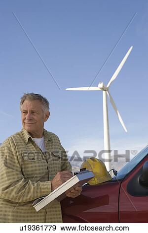 Stock Photo - Senior man working at wind farm. Fotosearch