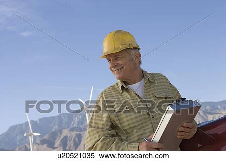 Senior man working at wind farm View Large Photo Image Stock Photography - Senior man working at wind farm. Fotosearch