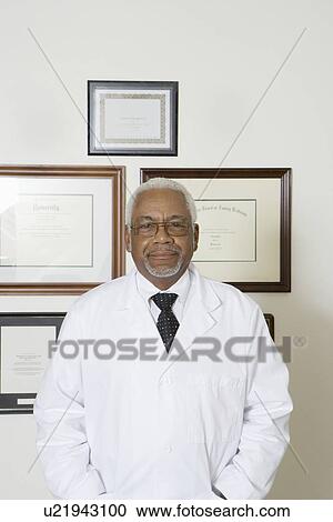 Senior medical practitioner and framed certificate View Large Photo Image Stock Image - Senior medical practitioner and framed certificate. Fotosearch