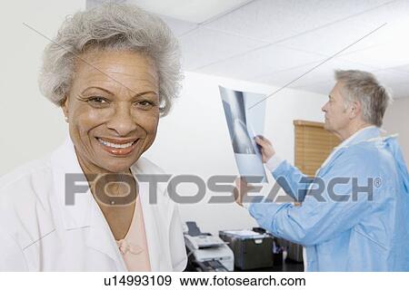 Senior medical practitioner and clipboard View Large Photo Image Stock Photo - Senior medical practitioner and clipboard. Fotosearch