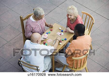 Senior people playing cards, smiling View Large Photo Image Stock Photo - Senior people playing cards, smiling. Fotosearch