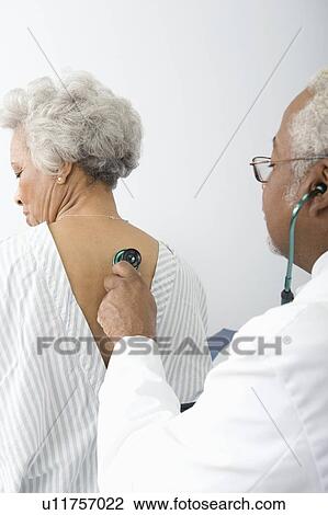 Senior practitioner listens to breathing through stethoscope View Large Photo Image Stock Image - Senior practitioner listens to breathing through stethoscope. Fotosearch