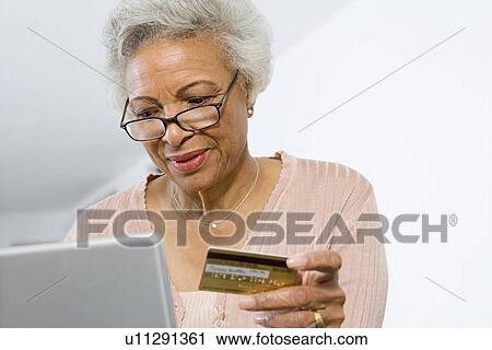 Senior Woman Using Laptop, Holding Credit Card View Large Photo Image Stock Image - Senior Woman Using Laptop, Holding Credit Card. Fotosearch