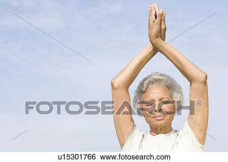 Senior woman with eyes closed in yoga pose View Large Photo Image Stock Photograph - Senior woman with eyes closed in yoga pose. Fotosearch