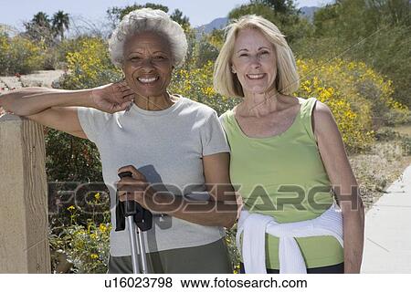 Stock Photo - Senior women stand with walking poles. Fotosearch