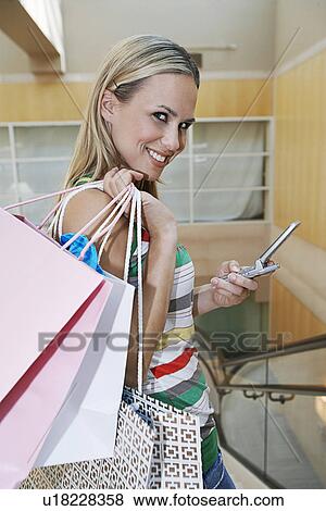 Stock Photo - Shopper Text Messaging. Fotosearch