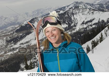 Skier Holding Skis on Mountain View Large Photo Image Stock Photo - Skier Holding Skis on Mountain. Fotosearch