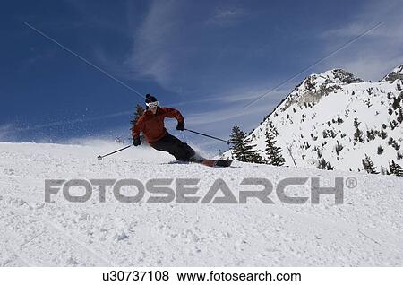 Stock Photo - Skier Skiing Down Slope. Fotosearch
