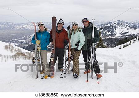 Stock Image - Skiers Holding Skis on Mountain. Fotosearch