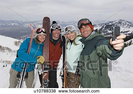 Stock Photo - Skiers Taking Their Picture With Cell Phone. Fotosearch