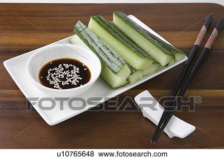 Soy sauce, cucumber and sesame seeds with chopsticks View Large Photo Image Stock Photo - Soy sauce, cucumber and sesame seeds with chopsticks. Fotosearch