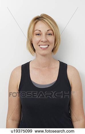 Stock Photo - Studio portrait of young woman smiling. Fotosearch