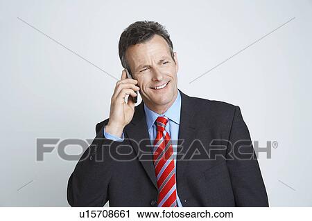 Studio shot of businessman talking on mobile phone View Large Photo Image Stock Image - Studio shot of businessman talking on mobile phone. Fotosearch