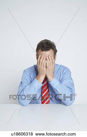Studio shot of businessman with head in hands View Large Photo Image Stock Photo - Studio shot of businessman with head in hands. Fotosearch