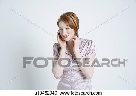 Studio shot of businesswoman talking on mobile phone View Large Photo Image Stock Photo - Studio shot of businesswoman talking on mobile phone. Fotosearch