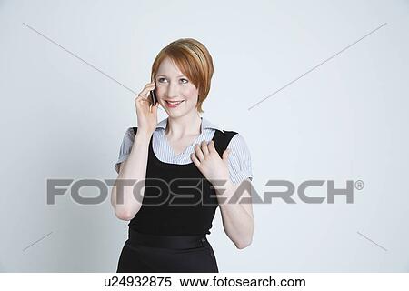 Stock Photography - Studio shot of businesswoman talking on mobile phone. Fotosearch