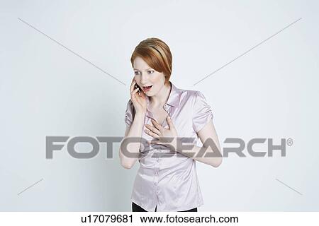 Studio shot of woman talking on mobile phone View Large Photo Image Stock Image - Studio shot of woman talking on mobile phone. Fotosearch