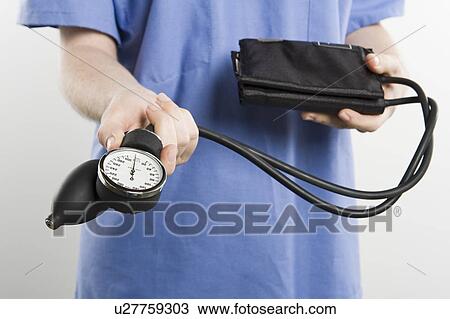 Surgeon with blood pressure gauge, mid section View Large Photo Image Stock Image - Surgeon with blood pressure gauge, mid section. Fotosearch