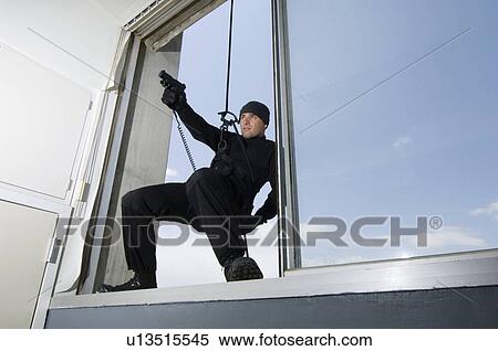 SWAT Team Officer Hanging from Window View Large Photo Image Stock Photography - SWAT Team Officer Hanging from Window. Fotosearch