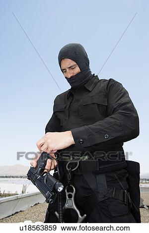 SWAT Team Officer Loading Pistol View Large Photo Image Stock Photo - SWAT Team Officer Loading Pistol. Fotosearch