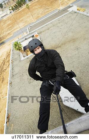 SWAT Team Officer Rappelling from Building View Large Photo Image Stock Image - SWAT Team Officer Rappelling from Building. Fotosearch