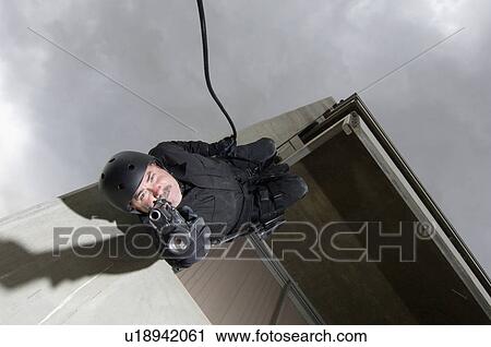 SWAT Team Officer Rappelling from Building View Large Photo Image Stock Image - SWAT Team Officer Rappelling from Building. Fotosearch