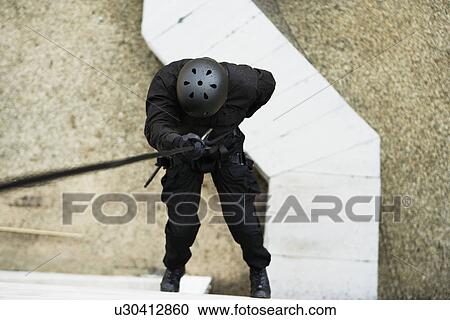 SWAT Team Officer Rappelling from Building View Large Photo Image Stock Image - SWAT Team Officer Rappelling from Building. Fotosearch