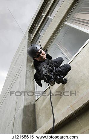 SWAT Team Officer Rappelling from Building View Large Photo Image Stock Photography - SWAT Team Officer Rappelling from Building. Fotosearch