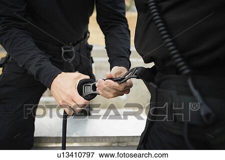Stock Photo - SWAT Team Preparing Climbing Equipment. Fotosearch