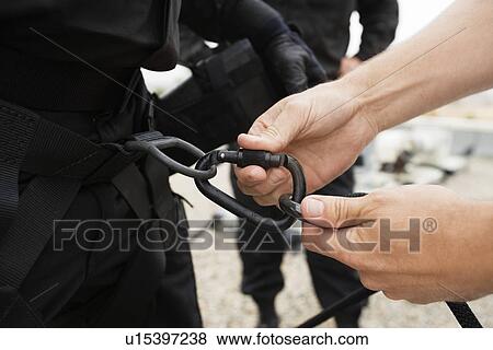 Stock Photo - SWAT Team Preparing Climbing Equipment. Fotosearch