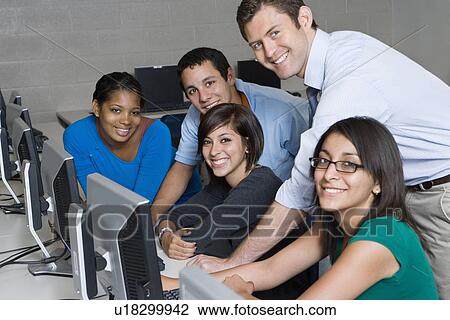 Stock Image - Teacher and Students in Computer Lab. Fotosearch