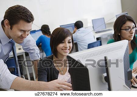 Picture - Teacher Helping Student in Computer Lab. Fotosearch