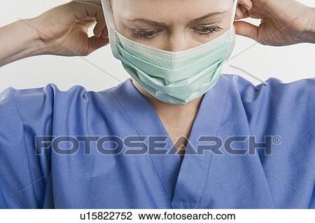 Stock Image - Threatre nurse adjusting mask. Fotosearch