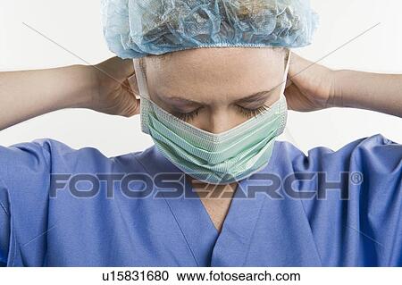 Stock Image - Threatre nurse adjusting mask. Fotosearch