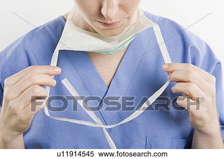 Stock Photography - Threatre nurse adjusting mask. Fotosearch