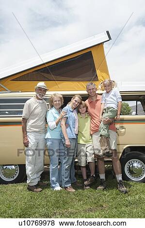 Stock Photo - Three generational family with campervan. Fotosearch