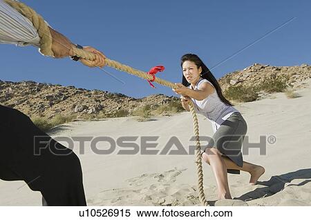 Two Business People Playing Tug of war in the Desert View Large Photo Image Stock Photography - Two Business People Playing Tug of war in the Desert. Fotosearch