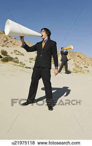 Two Businessmen Using Megaphones in Desert View Large Photo Image Stock Photo - Two Businessmen Using Megaphones in Desert. Fotosearch