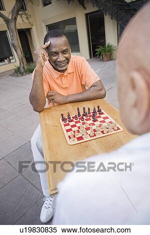 Two senior men playing chess View Large Photo Image Stock Photography - Two senior men playing chess. Fotosearch
