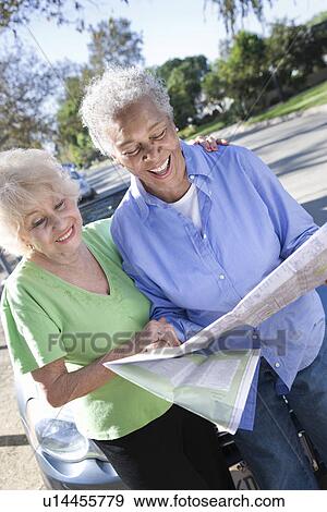 Two senior women reading map, smiling View Large Photo Image Stock Photo - Two senior women reading map, smiling. Fotosearch