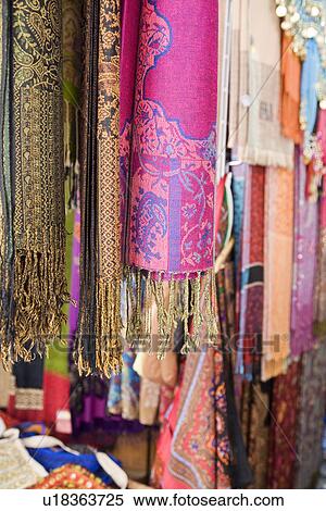 Stock Photography - UAE, Dubai, colourful pashminas and fabrics for sale at Bur Dubai souq. Fotosearch