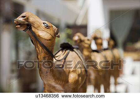 UAE, Dubai, wooden carved camels on display in the old Bastakia Quarter in Bur Dubai View Large Photo Image Stock Photograph - UAE, Dubai, wooden carved camels on display in the old Bastakia Quarter in Bur Dubai. Fotosearch