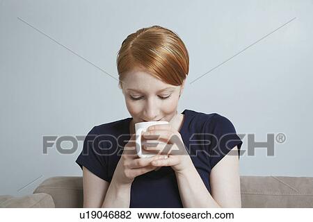 Woman drinking from cup View Large Photo Image Stock Image - Woman drinking from cup. Fotosearch