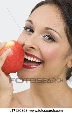Stock Photo - Woman eating apple. Fotosearch