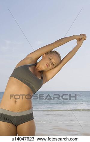 Woman exercising at beach View Large Photo Image Stock Image - Woman exercising at beach. Fotosearch