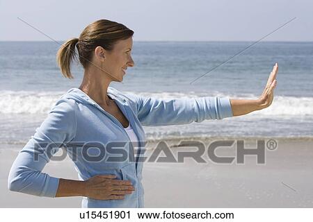 Woman exercising at beach View Large Photo Image Stock Image - Woman exercising at beach. Fotosearch