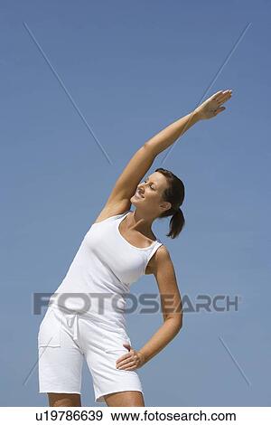 Woman exercising at beach View Large Photo Image Stock Photo - Woman exercising at beach. Fotosearch