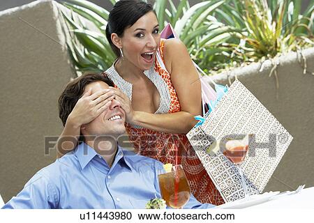 Stock Image - Woman Hiding a Man's Eyes. Fotosearch