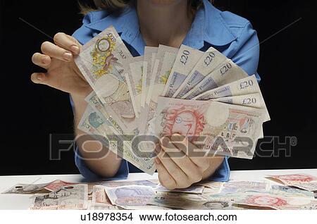 Woman holding fan of banknotes View Large Photo Image Picture - Woman holding fan of banknotes. Fotosearch