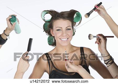 Woman in rollers, with cosmetics products on hand View Large Photo Image Stock Image - Woman in rollers, with cosmetics products on hand. Fotosearch